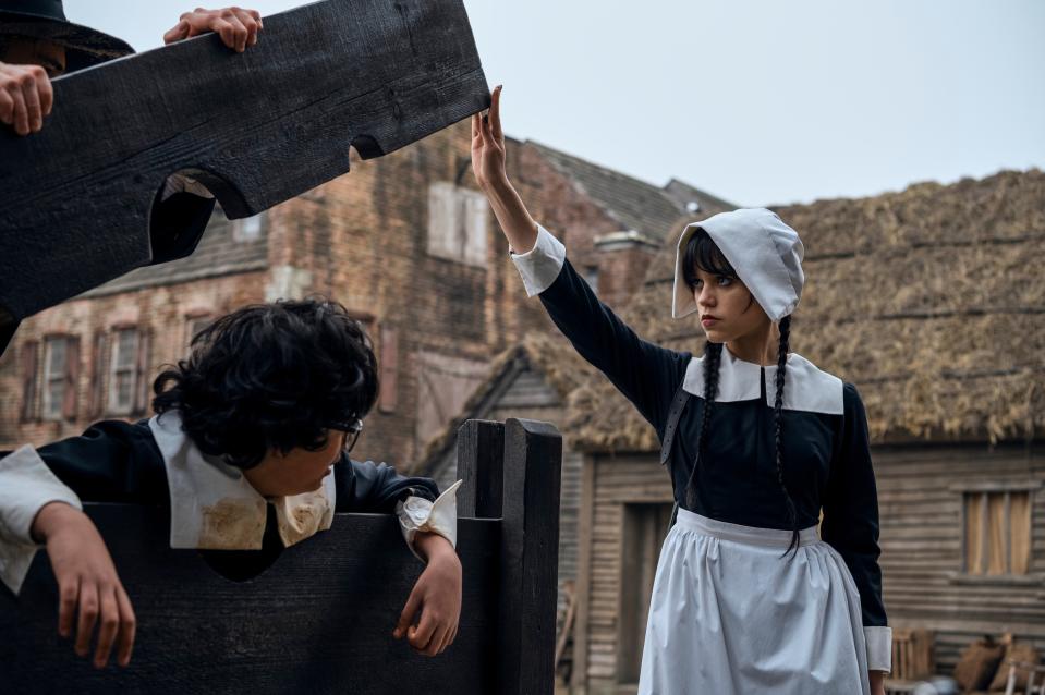 Wednesday frees Eugene (Moosa Mostafa) from the stocks at Pilgrim World, where he was trapped by bullies.<span class="copyright">Vlad Cioplea—Netflix</span>