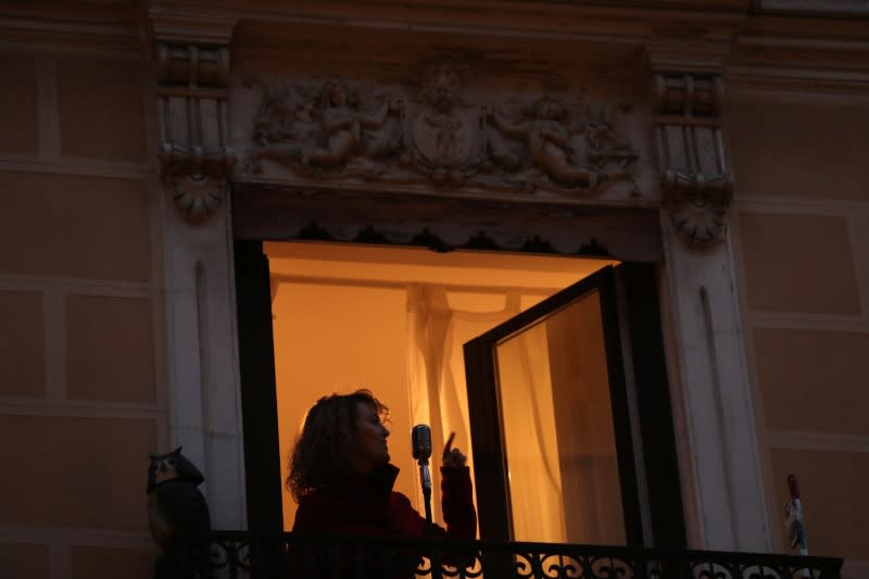 Spanish blues singer "Betta" sings from her balcony during a daily evening concert to support health workers and to make it easier for her neighbours to bear the coronavirus lockdown in Madrid