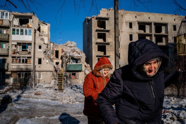 Elderly local residents walk past a destroyed residential building in Chasiv Yar, Eastern Ukraine (AFP via Getty Images)