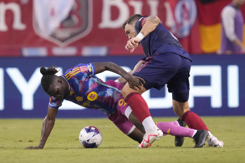 Toronto FC forward C.J. Sapong, left, and Chicago Fire defender Rafael Czichos battle for the ball in the first half of an MLS soccer match Saturday, July 15, 2023, in Chicago. (AP Photo/Charles Rex Arbogast)