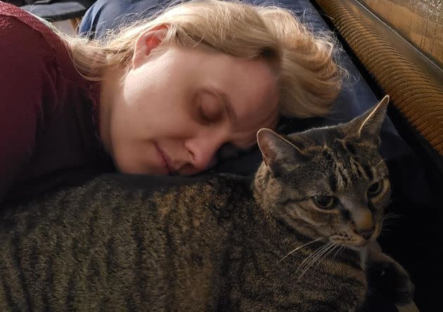 The author rests with her cat Star in July 2020. 