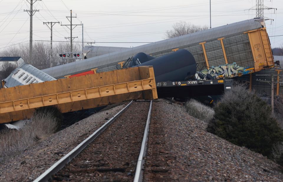Multiple cars of a Norfolk Southern train lie toppled after derailing at a train crossing with Ohio 41 in Clark County, Ohio, Saturday, March 4, 2023. (Bill Lackey/Springfield-News Sun via AP)