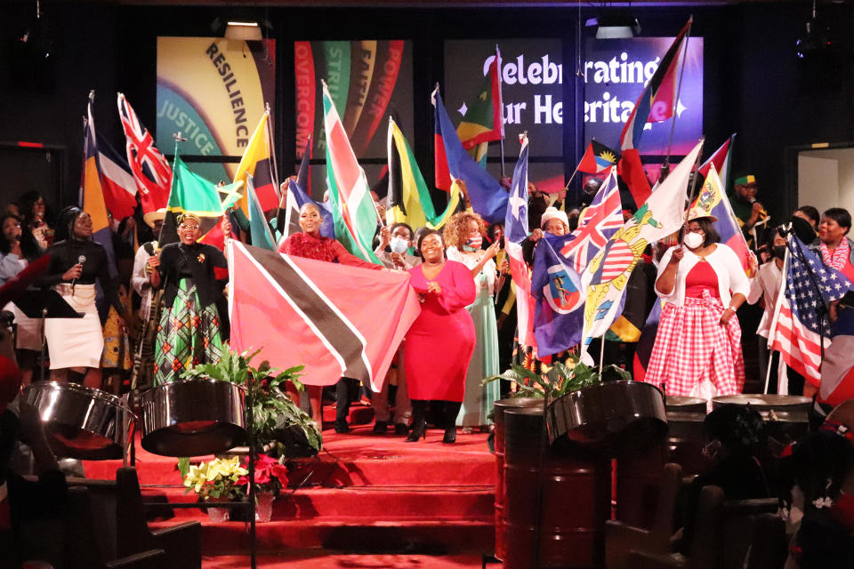 Flag bearers representing different countries stand at the front of Metropolitan Seventh-day Adventist Church after processing into the sanctuary for "Caribbean Sabbath" at the Hyattsvile, Md., church on Saturday, Feb. 18, 2023. (Adelle M. Banks/RNS via AP)