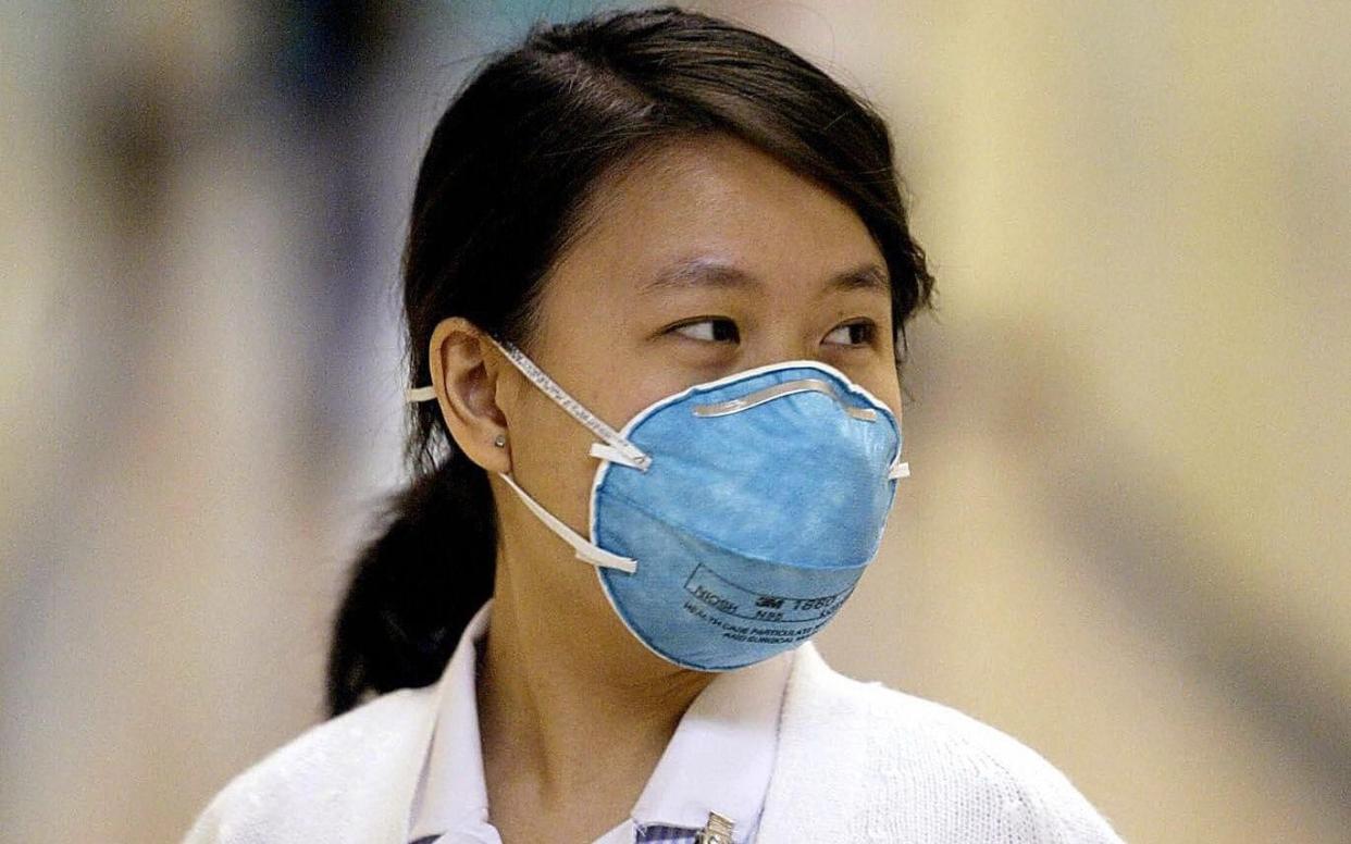 A nurse in Hong Kong working during the SARS outbreak in 2003, which killed 700 people - AFP