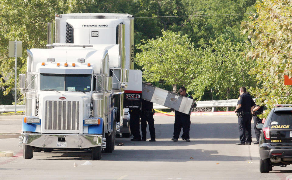 <p>Police officers work on a crime scene after eight people believed to be illegal immigrants being smuggled into the United States were found dead inside a sweltering 18-wheeler trailer parked behind a Walmart store in San Antonio, Texas, July 23, 2017. (Ray Whitehouse/Reuters) </p>