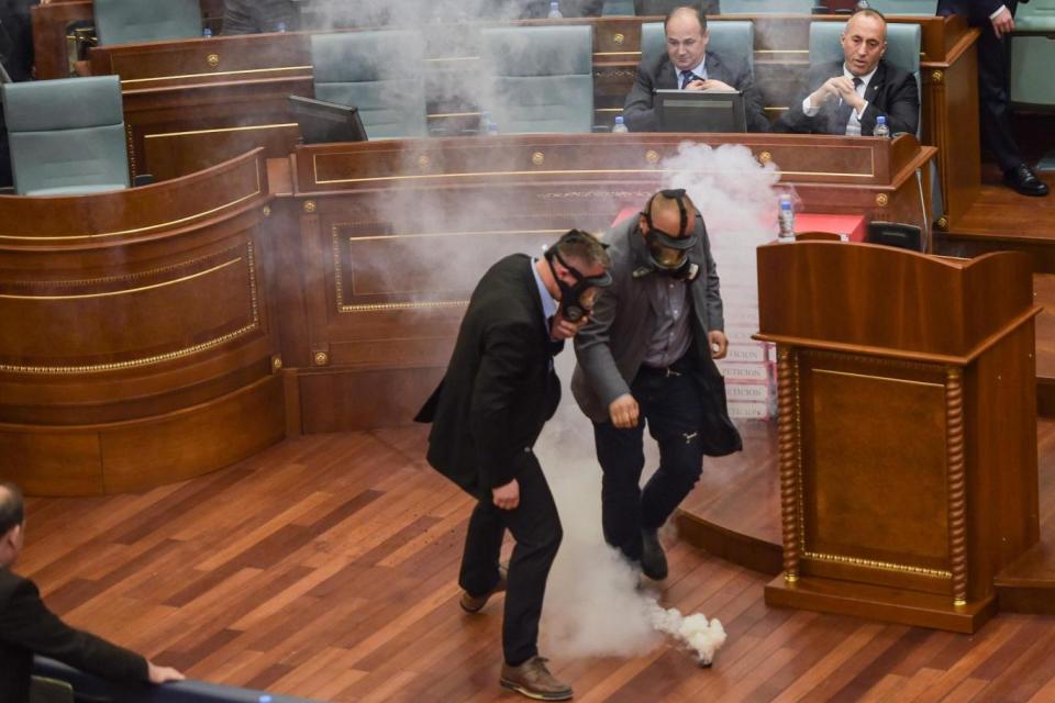 Police prepare to remove a tear gas canister (AFP/Getty Images)