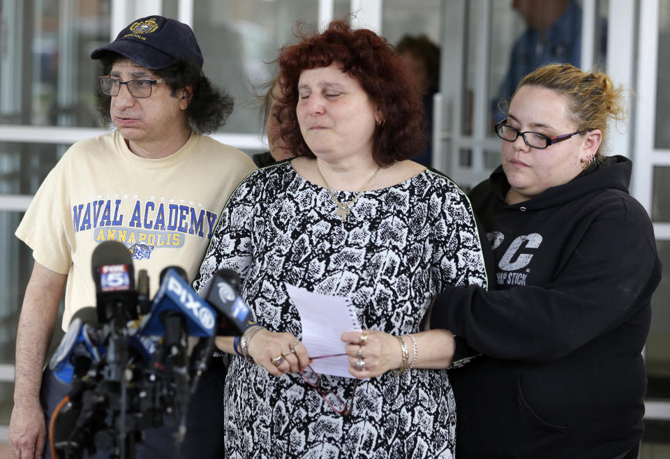 Surrounded by friends and family, Susan Zemser, center, and Howard Zemser, the parents of U.S. Naval Academy Midshipman Justin Zemser, prepare to speak to the media outside their home in New York, Wednesday, May 13, 2015. Zemser, 20, who was on leave and heading home to Rockaway Beach, N.Y., was killed when an Amtrak passenger train derailed and overturned in Philadelphia on the nation&#39;s busiest rail corridor Tuesday night. (AP Photo/Seth Wenig)