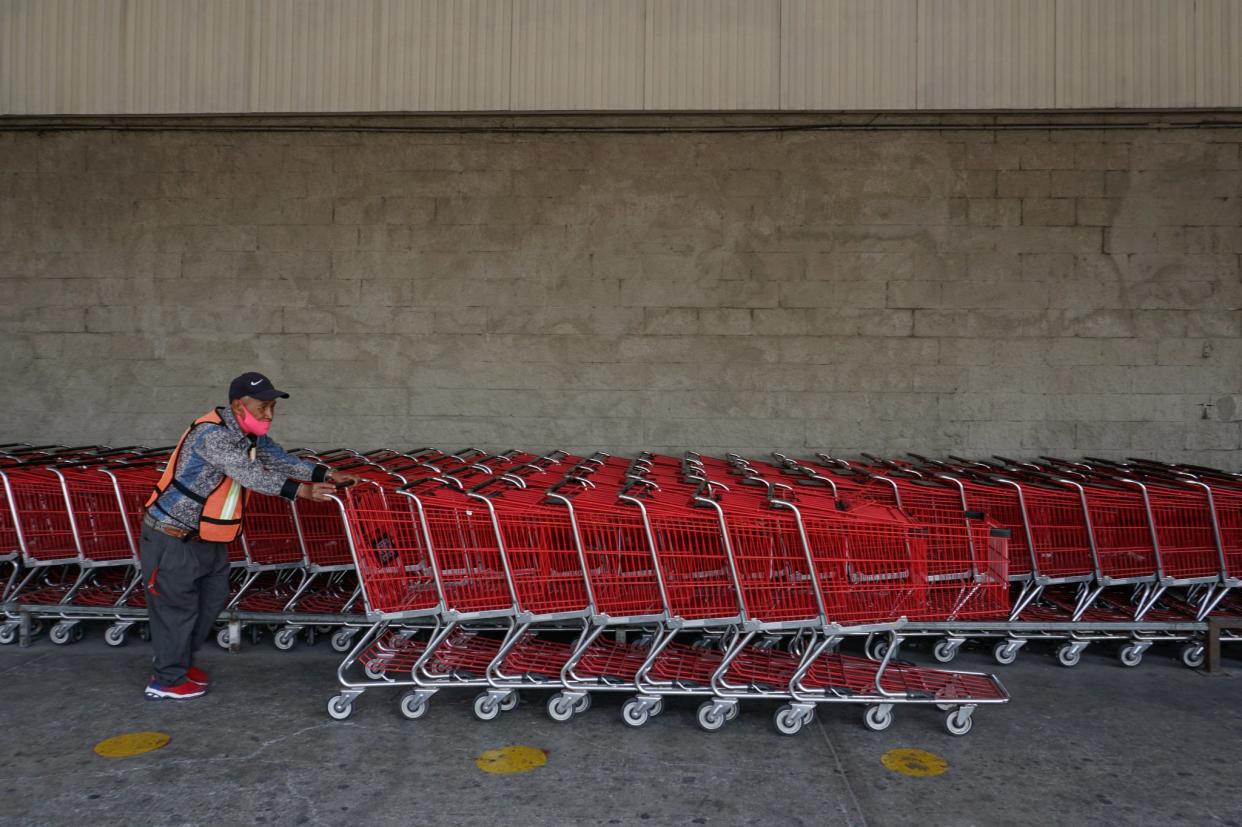 Francisco Alarcón Muñoz acomoda los carritos de compras en la tienda donde trabaja como viene viene.