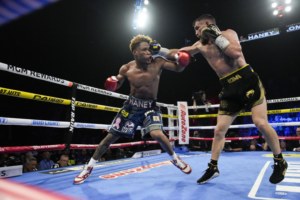 Devin Haney, left, fights Vasiliy Lomachenko in an undisputed lightweight championship boxing match Saturday, May 20, 2023, in Las Vegas. Haney won by unanimous decision. (AP Photo/John Locher)