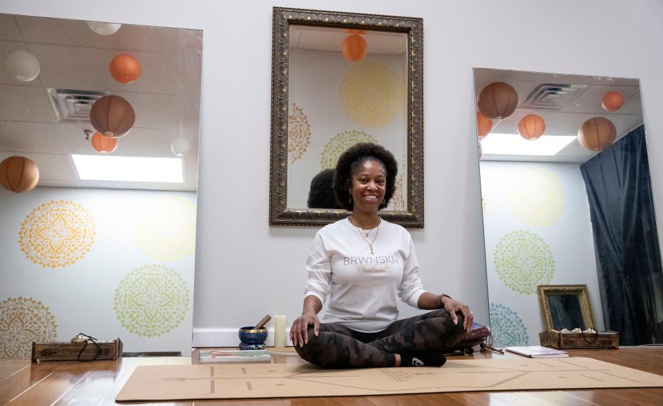 Owner Shawandra Ford sits on her mat in BRWNSKN Yoga, a studio she created to promote inclusivity in yoga, Monday, May 16, 2022, in Memphis. 