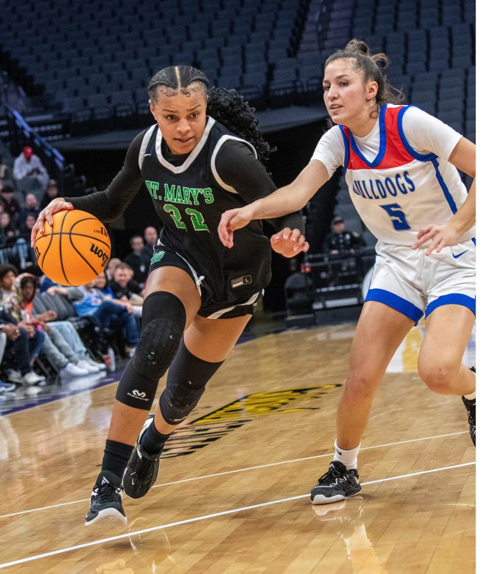 St. Mary's Jordan Lee tries to drive past Folsom's Ella Uriarte in the girls division 1 Section Finals at the Golden One Arena in Sacramento on Feb 25, 2023.