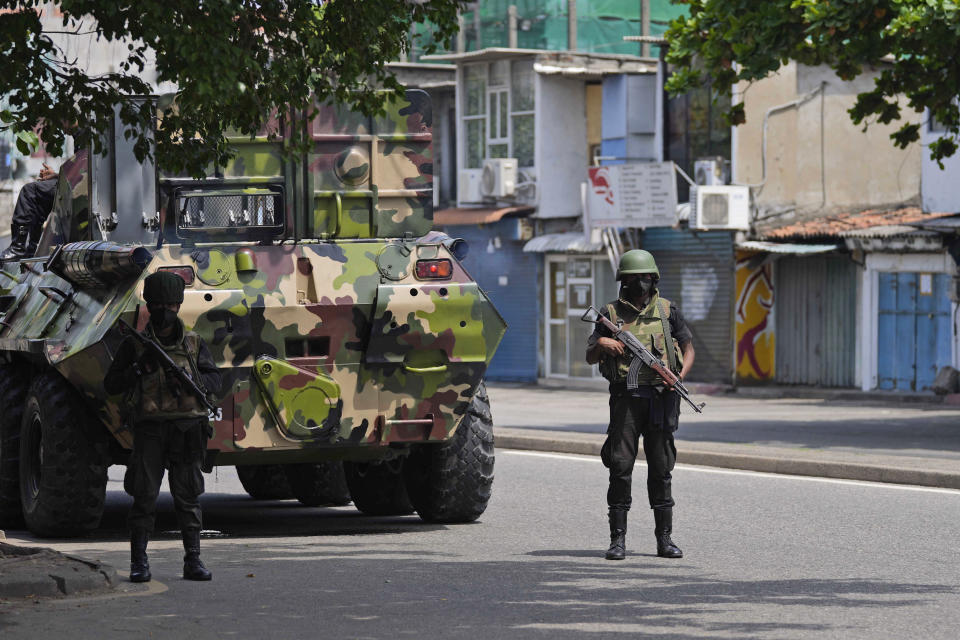 Sri Lankan army soldiers patrol during curfew in Colombo, Sri Lanka, Wednesday, May 11, 2022. Sri Lankan authorities deployed armored vehicles and troops on the streets of the capital Wednesday, two days after pro-government mobs attacked peaceful protesters, triggering a wave of violence across the country. (AP Photo/Eranga Jayawardena)