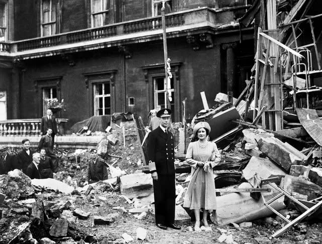 King George VI and the Queen Mother survey bomb damage at Buckingham Palace - care home residents told William and Kate about air attacks they had suffered. PA Wire