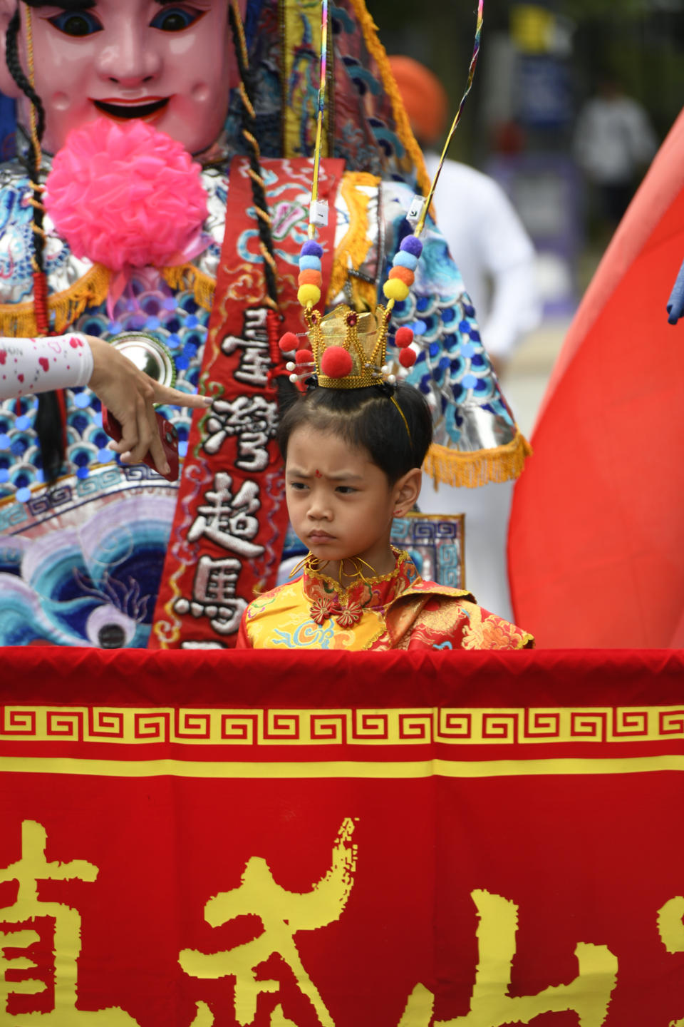 A young parade participant looks on before the Parliament of World Religion Parade of Faiths, Sunday, Aug. 13, 2023, in Chicago. (AP Photo/Paul Beaty)