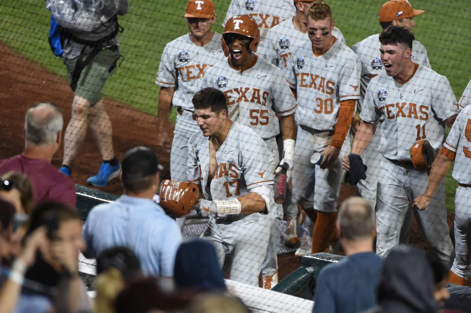 Texas' Ivan Melendez celebrates with teammates after hitting a dramatic three-run homer in the ninth inning in last year's CWS against Mississippi State. It was a precursor of 2022; Melendez has hit 32 home runs this season to lead the country.