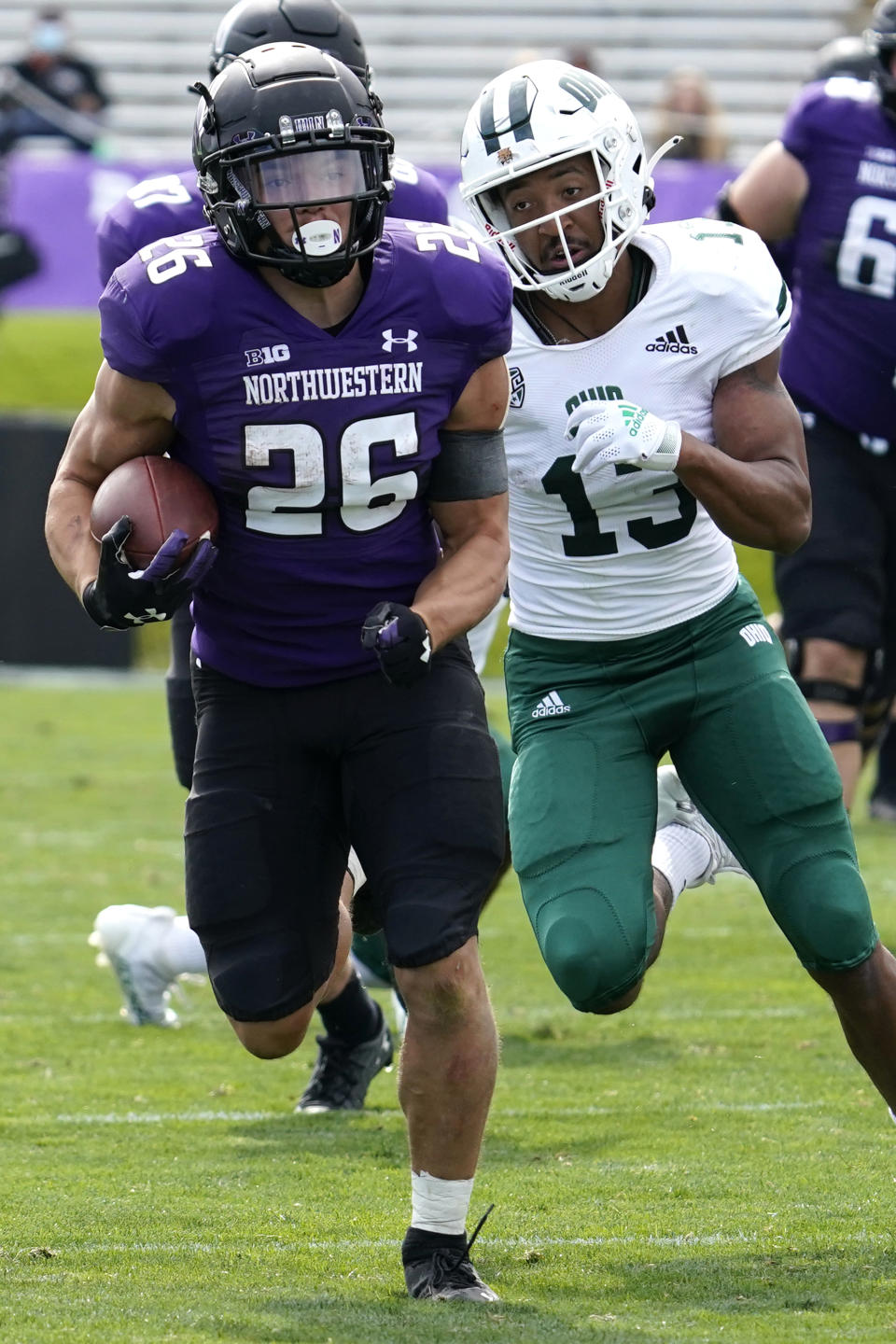 Northwestern running back Evan Hull runs with the ball past Ohio cornerback John Gregory during the second half of an NCAA college football game in Evanston, Ill., Saturday, Sept. 25, 2021. Northwestern won 35-6. (AP Photo/Nam Y. Huh)