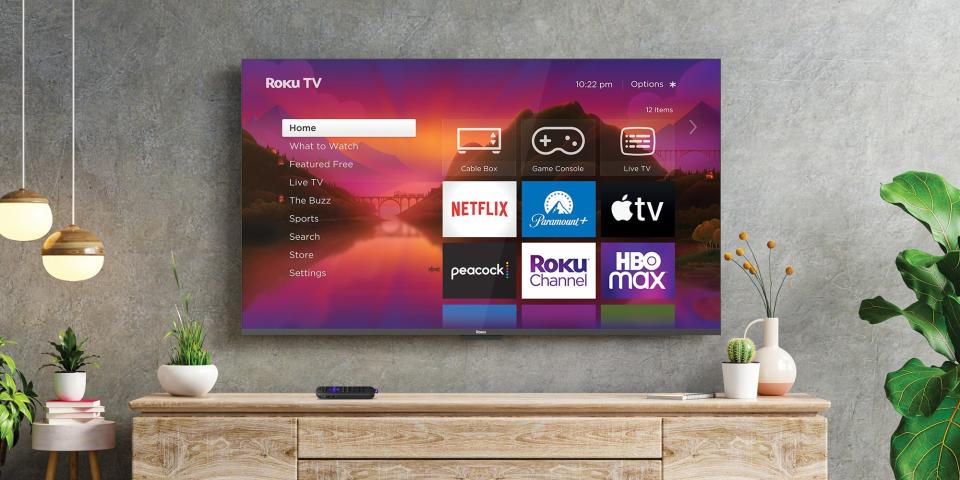 Roku 2023 TV hanging on a wall with the Roku menu on screen.