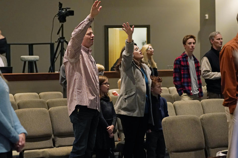 Congregants sing along with the choir at Highland Colony Baptist Church in Ridgeland, Miss., Nov. 29, 2020. The church practices covid protocols by allowing families to sit spaced out from others, separating older and more vulnerable members in the Worship Center and providing sanitizer and masks at the entrance. (AP Photo/Rogelio V. Solis)