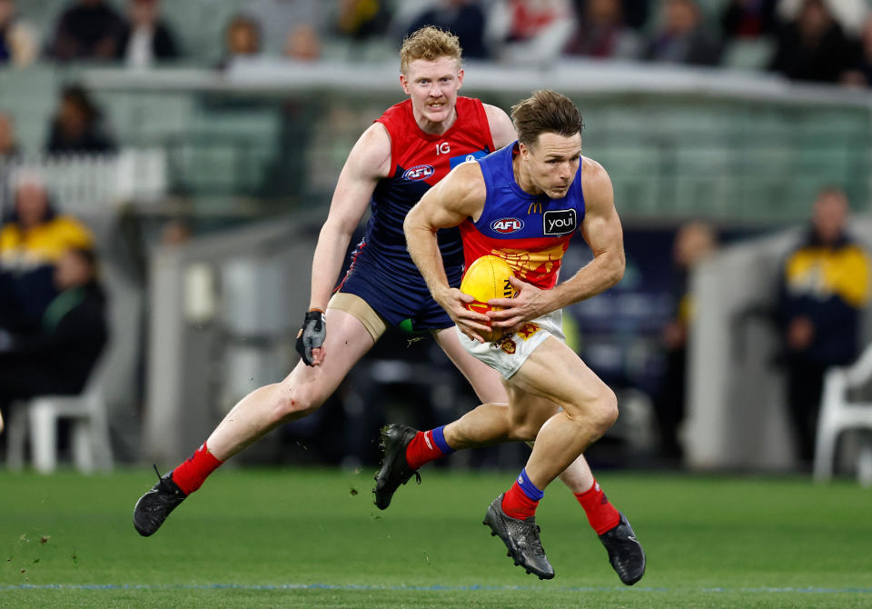 MELBOURNE, AUSTRALIA - APRIL 11: Lincoln McCarthy of the Lions and Clayton Oliver of the Demons compete for the ball during the 2024 AFL Round 05 match between the Melbourne Demons and the Brisbane Lions at the Melbourne Cricket Ground on April 11, 2024 in Melbourne, Australia. (Photo by Michael Willson/AFL Photos via Getty Images)