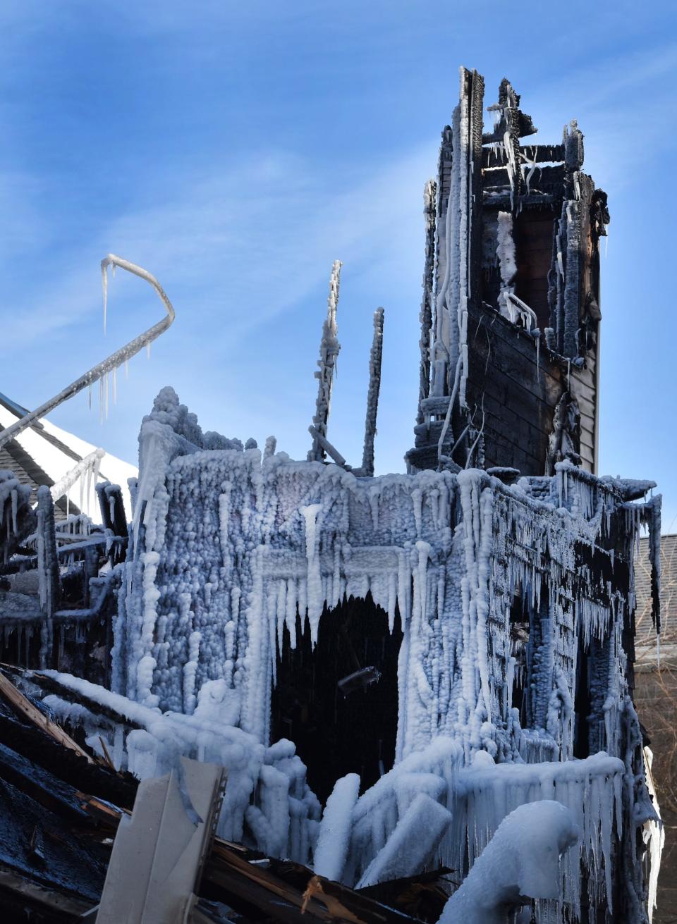 Ice covers much of the scene where a massive fire burned at 140 Irving St., Fall River, in blizzard conditions.