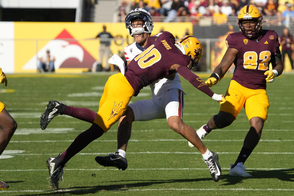 Arizona State running back Cameron Skattebo, top left, is hit by Arizona State defensive back Ed Woods (10) after making a catch in the first half during an NCAA college football game, Saturday, Nov. 25, 2023, in Tempe, Ariz. (AP Photo/Rick Scuteri)