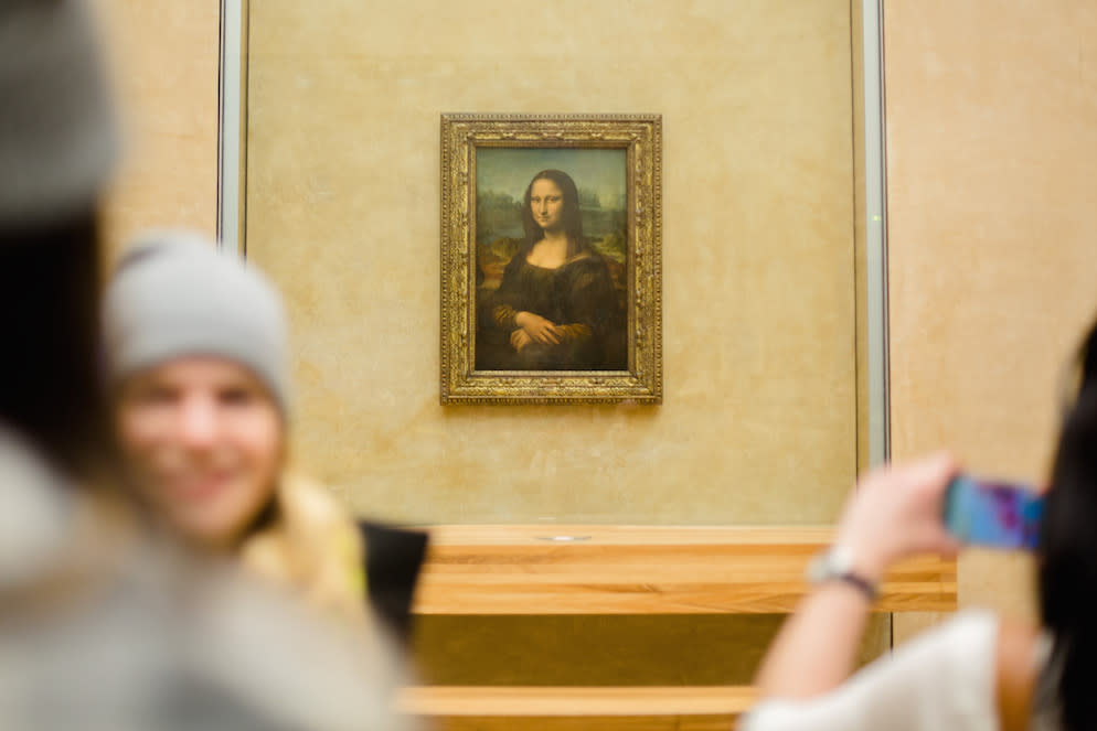 Visitors take pictures of Leonardo da Vinci’s Mona Lisa inside the Louvre museum in Paris (Picture: Getty)