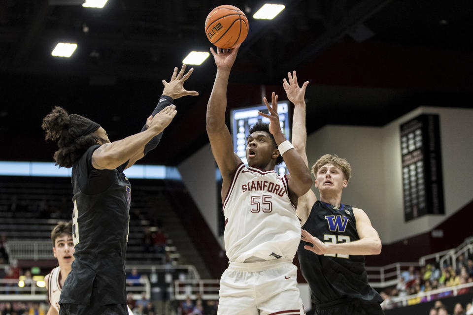 Washington forward Langston Wilson, left, and guard Cole Bajema, right, defend against Stanford forward Harrison Ingram (55) during the first half of an NCAA college basketball game in Stanford, Calif., Sunday, Feb. 26, 2023. (AP Photo/John Hefti)