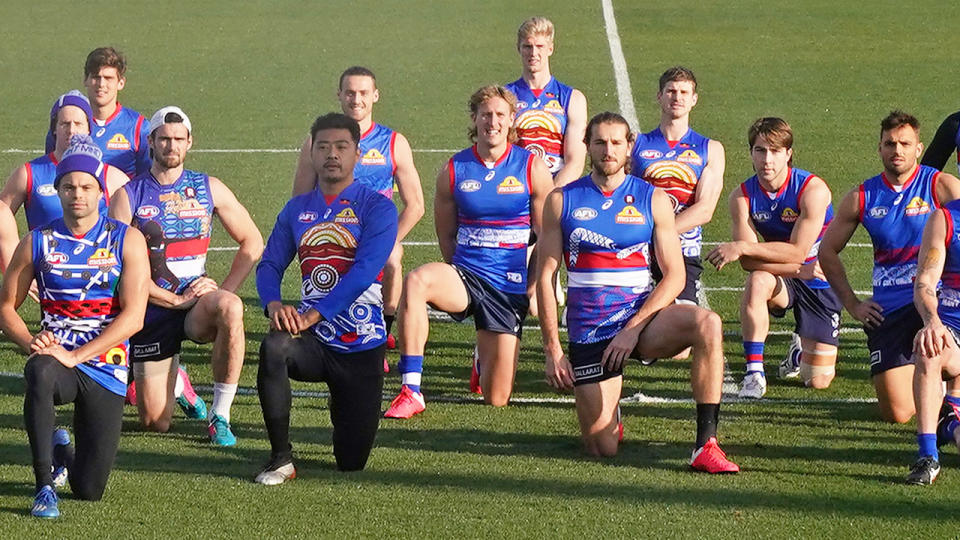 Seen here, Western Bulldogs layers kneel at training in support of the BLM movement.