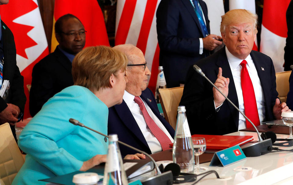 <p>German Chancellor Angela Merkel (L) sits next to Tunisia’s President Beji Caid Essebsi (C) and speaks to U.S. President Donald Trump (R) as they attend a G7 expanded session during the G7 Summit in Taormina, Sicily, Italy, May 27, 2017. (Photo: Philippe Wojazer/Reuters) </p>