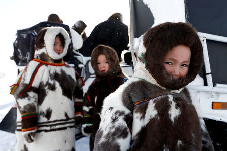 Children from the indigenous community "Yamb To" (Long Lake) are seen at a reindeer camping ground, about 450 km northeast of Naryan-Mar, in Nenets Autonomous District, Russia, March 1, 2018. REUTERS/Sergei Karpukhin