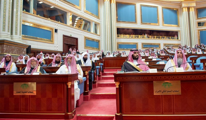 Saudi Crown Prince Mohammed bin Salman sits next to Saudi Arabia's Grand Mufti Sheikh Abdulaziz Al al-Sheikh as they attend a session of the Shura Council in Riyadh