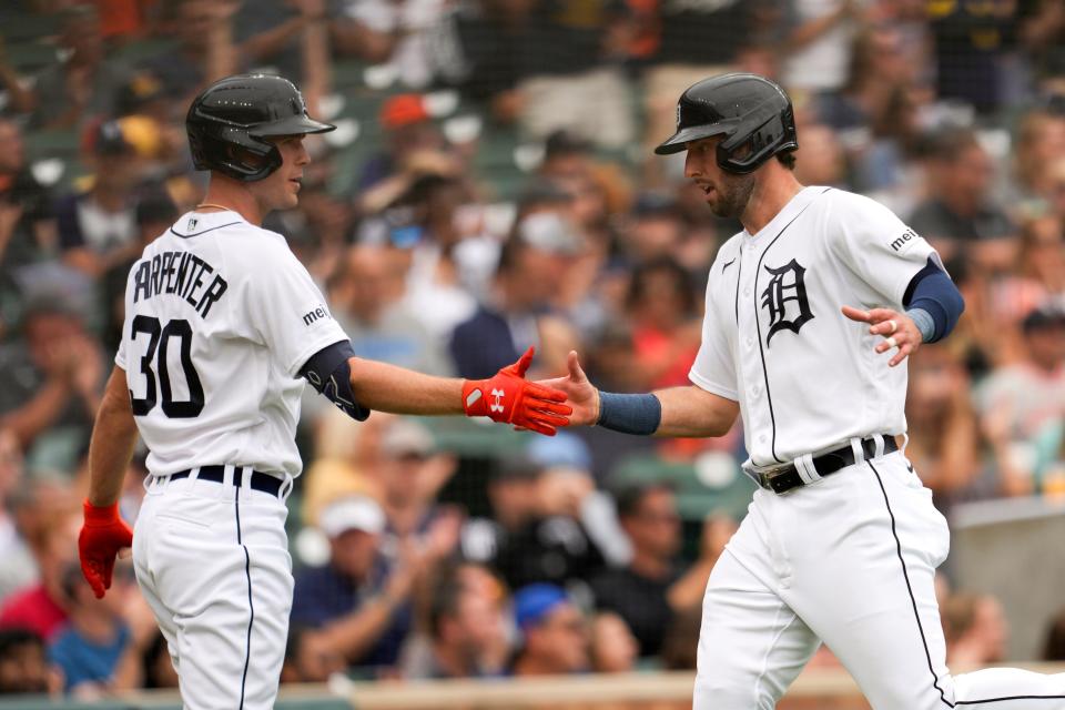 Detroit Tigers' Kerry Carpenter (30) and Matt Vierling celebrate scoring against the Chicago White Sox in the third inning at Comerica Park in Detroit on Sunday, Sept. 10, 2023.