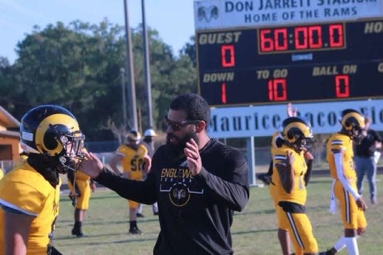 Englewood head coach Zach Harbison speaks with his team before a 2022 high school football game. Tocoi Creek hired Harbison as its next football coach Tuesday.