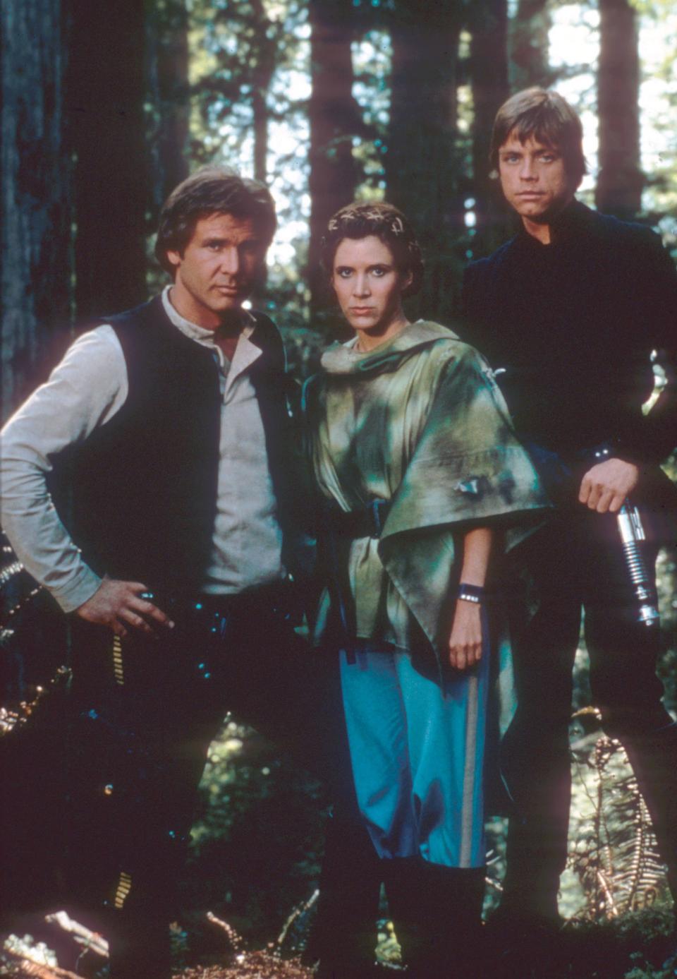 Harrison Ford as Han Solo, Carrie Fisher as Princess Leia, and Mark Hamill as Luke Skywalker in a promotional shot for <em>Return of the Jedi.</em> (Photo: Mary Evans/Lucasfilm/Ronald Grant/Everett Collection)