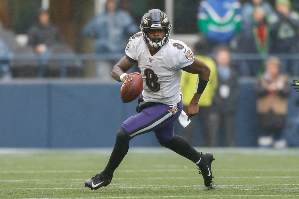 SEATTLE, WA - OCTOBER 20:  Quarterback Lamar Jackson #8 of the Baltimore Ravens rolls out to pass against the Seattle Seahawks at CenturyLink Field on October 20, 2019 in Seattle, Washington.  (Photo by Otto Greule Jr/Getty Images)