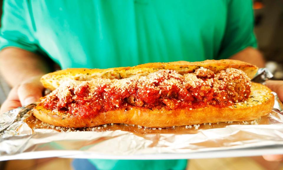 Mike Garibaldi Jr. holds a meatball sub at Garibaldi’s Pizza's Mount Moriah location in Memphis on Sept. 19, 2023. Garibaldi’s Pizza has been a Memphis favorite since 1975 and has three locations in the Memphis area.