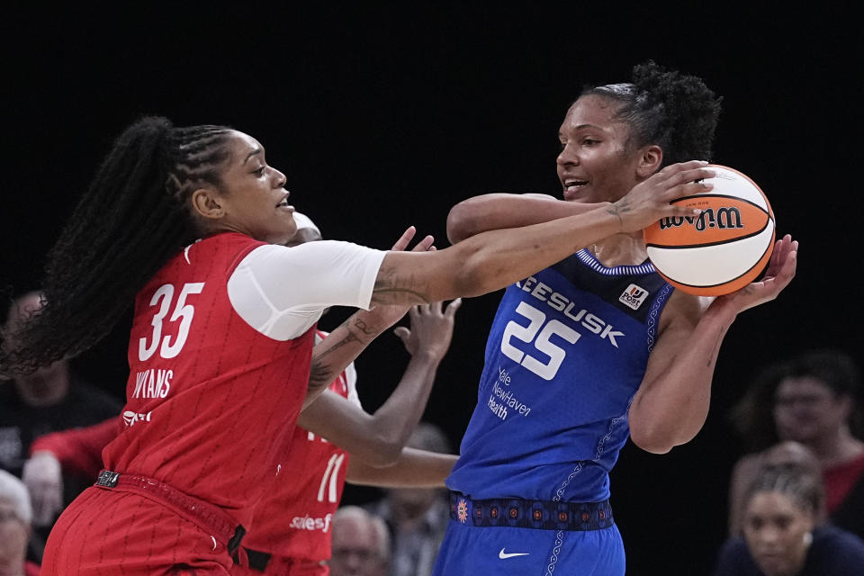 Indiana Fever's Victoria Vivians (35) deflects the ball from Connecticut Sun's Alyssa Thomas (25) during the second half of a WNBA basketball game Friday, May 19, 2023, in Indianapolis. (AP Photo/Darron Cummings)