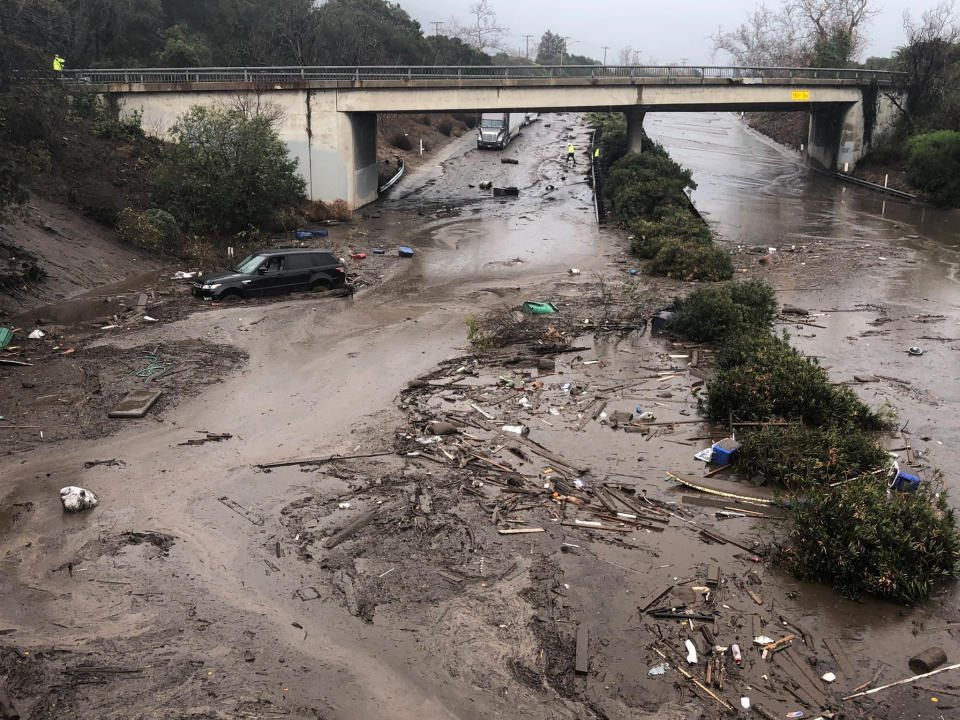 Abandoned vehicles are mired on the&nbsp;flooded freeway.