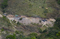 Tarps set up by people illegally mining for gold dot the Raposa Serra do Sol Indigenous reserve in Roraima state, Brazil, Saturday, Nov. 6, 2021. The number of wildcat miners at sites across the reserve has surged to some 2,000, according to Edinho Batista Macuxi, general coordinator of Roraima's Indigenous Council. (AP Photo/Andre Penner)