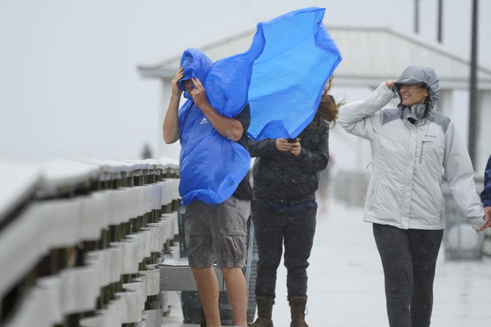 People walk on the Ballast Point Pier 