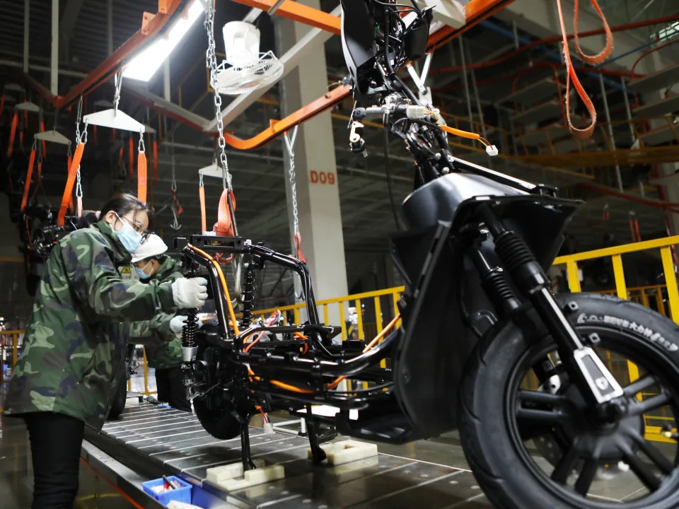 An employee works on the assembly line of electric bicycles at a workshop of Yadea Technology Group Co., Ltd.