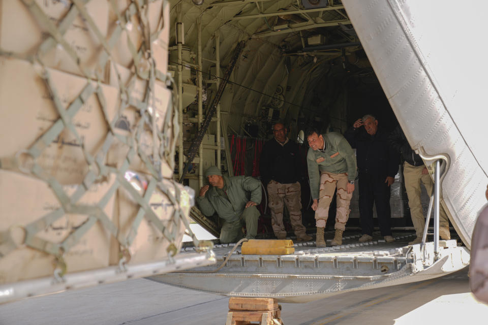 Iraqi security forces prepare humanitarian aid from Red Crescent that will be shipped on a plane of emergency relief to the earthquake affected people of Syria, at a military airbase near Baghdad International Airport in Baghdad, Iraq, Sunday, Feb. 12, 2023. (AP Photo/Hadi Mizban)