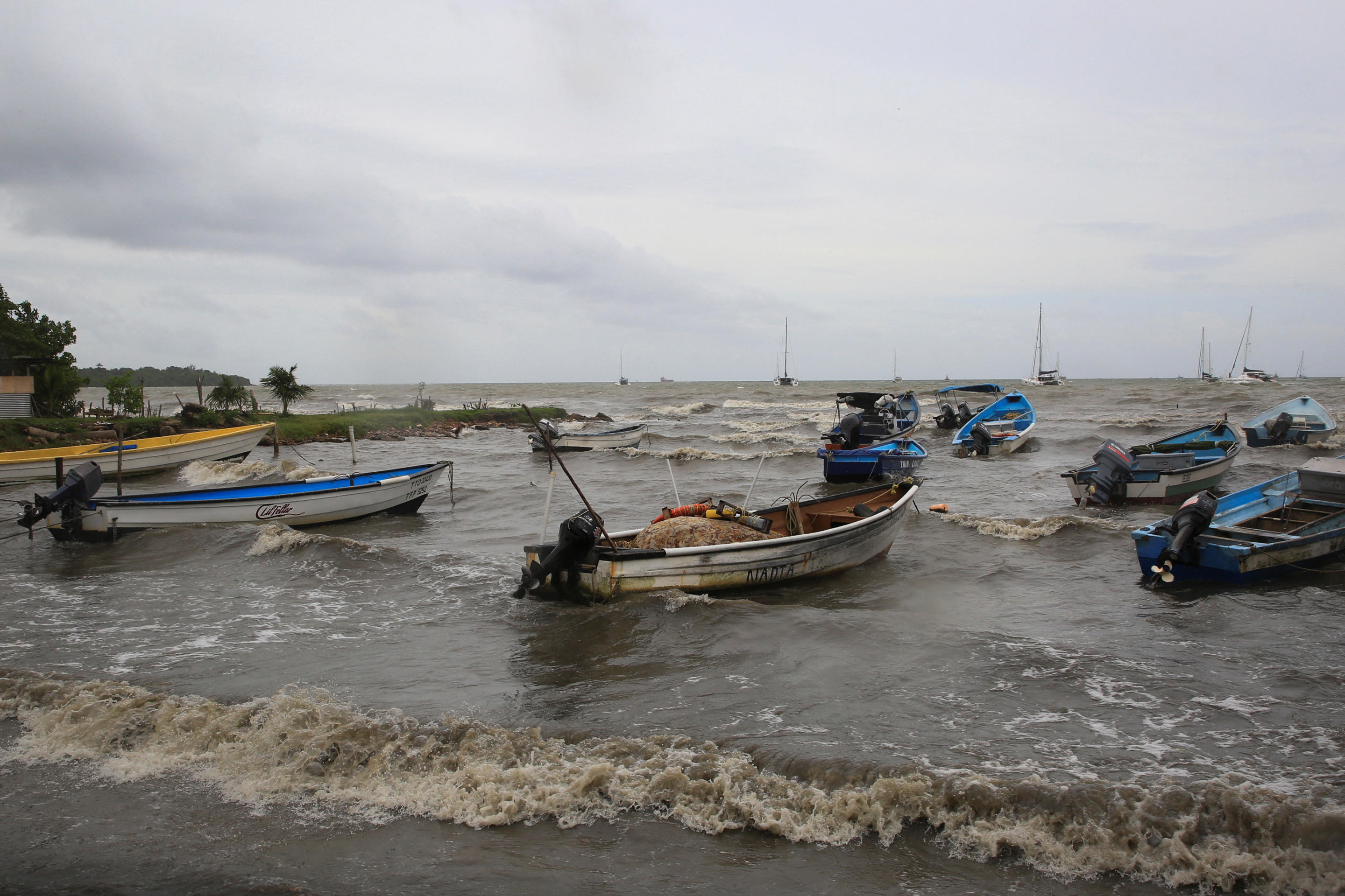 About a dozen small boats in the water near the shore after Hurricane Beryl made landfall in Port of Spain, the capital of Trinidad and Tobago. 