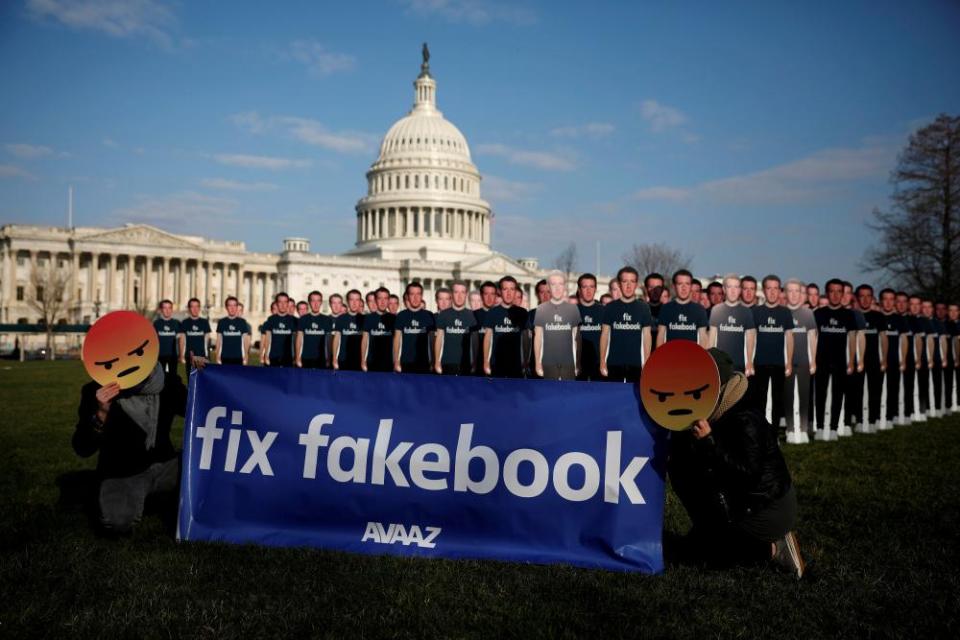 Protesters outside the US Capitol in Washington as Mark Zuckerberg testifies about Facebook’s privacy policies.