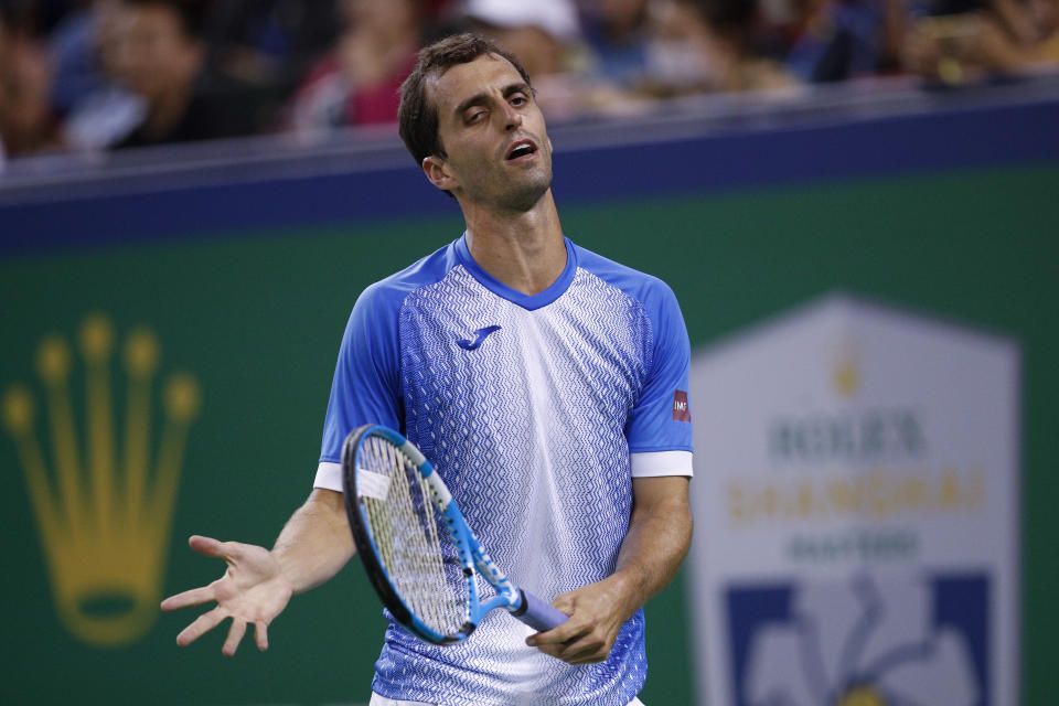 Albert Ramos-Vinolas of Spain reacts as he plays against Roger Federer of Switzerland during the men's singles match at the Shanghai Masters tennis tournament at Qizhong Forest Sports City Tennis Center in Shanghai, China, Tuesday, Oct. 8, 2019. (AP Photo/Andy Wong)