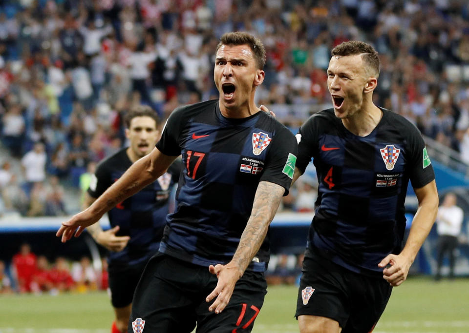 <p>Mario Mandzukic celebrates scoring his goal which hauled Croatia to 1-1 early in the match </p>