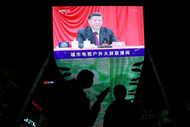 FILE PHOTO: Giant screen shows Chinese President Xi Jinping attending the sixth plenary session of the 19th Central Committee of the Communist Party of China (CPC), in Beijing