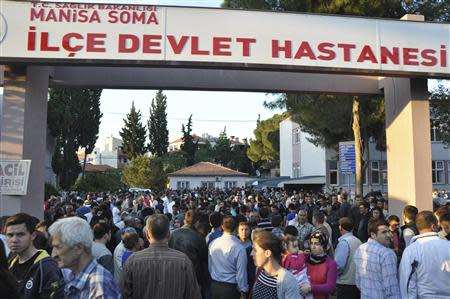 Locals and relatives of miners who are trapped in a coal mine wait in front of a hospital in Soma, a district in Turkey's western province of Manisa May 13, 2014. REUTERS/Ihlas/Yilmaz Saripinar