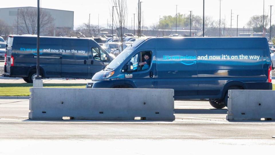 Delivery drivers head into a delivery bay.