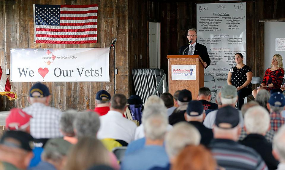 Veteran Steve Carroll gives the keynote address during a service honoring veterans at the Ashland County Fair on Monday.